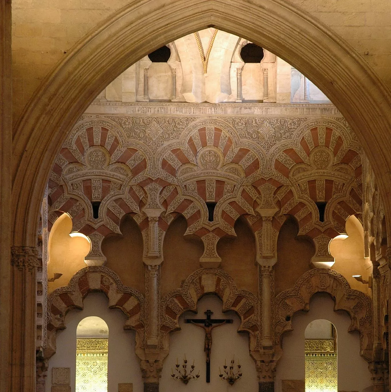 arches in the mosque in cordoba with crucifix
